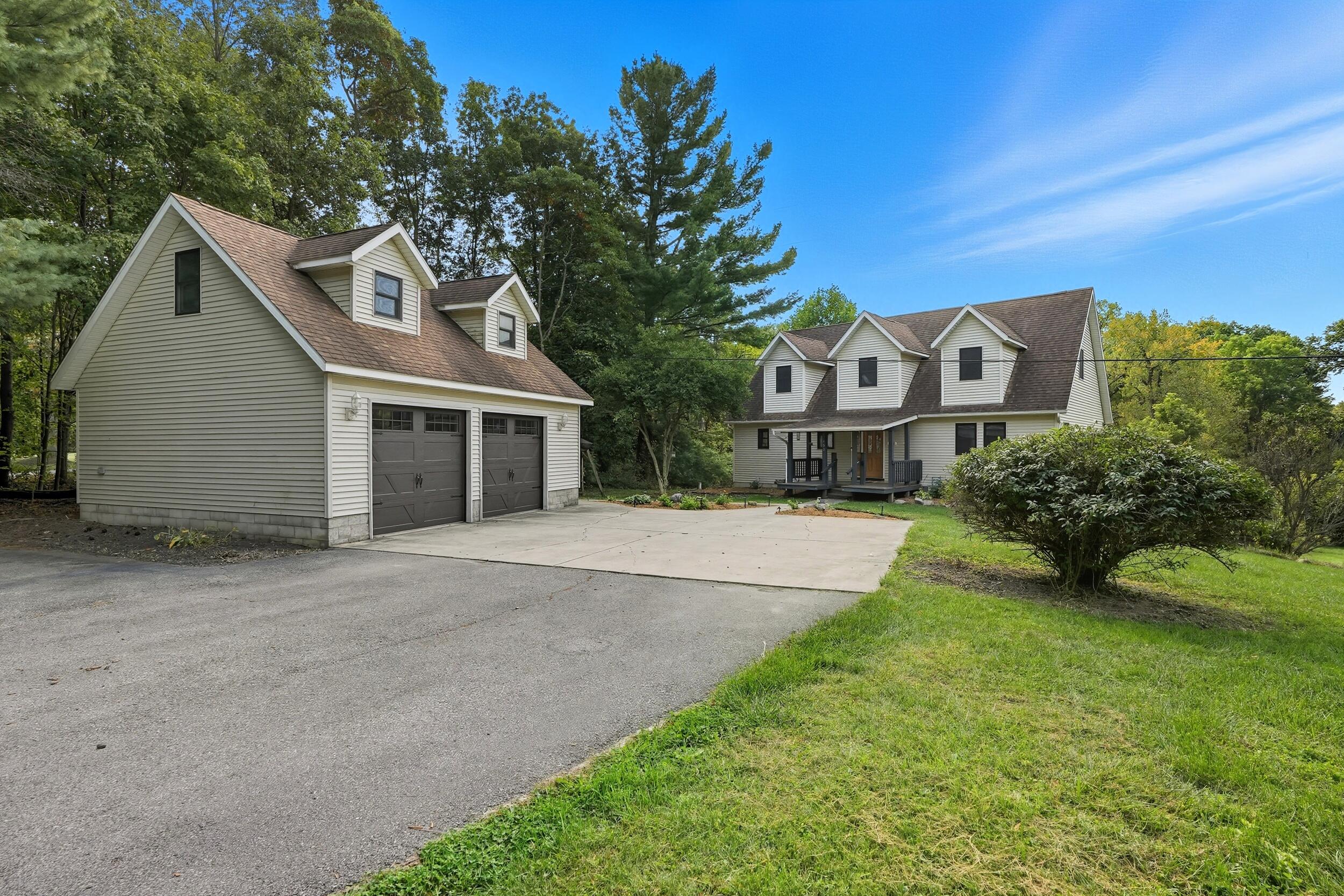 450 East Greening Road Chesterton, IN 46304 - Photo 3 of 56 a front view of a house with a yard and garage