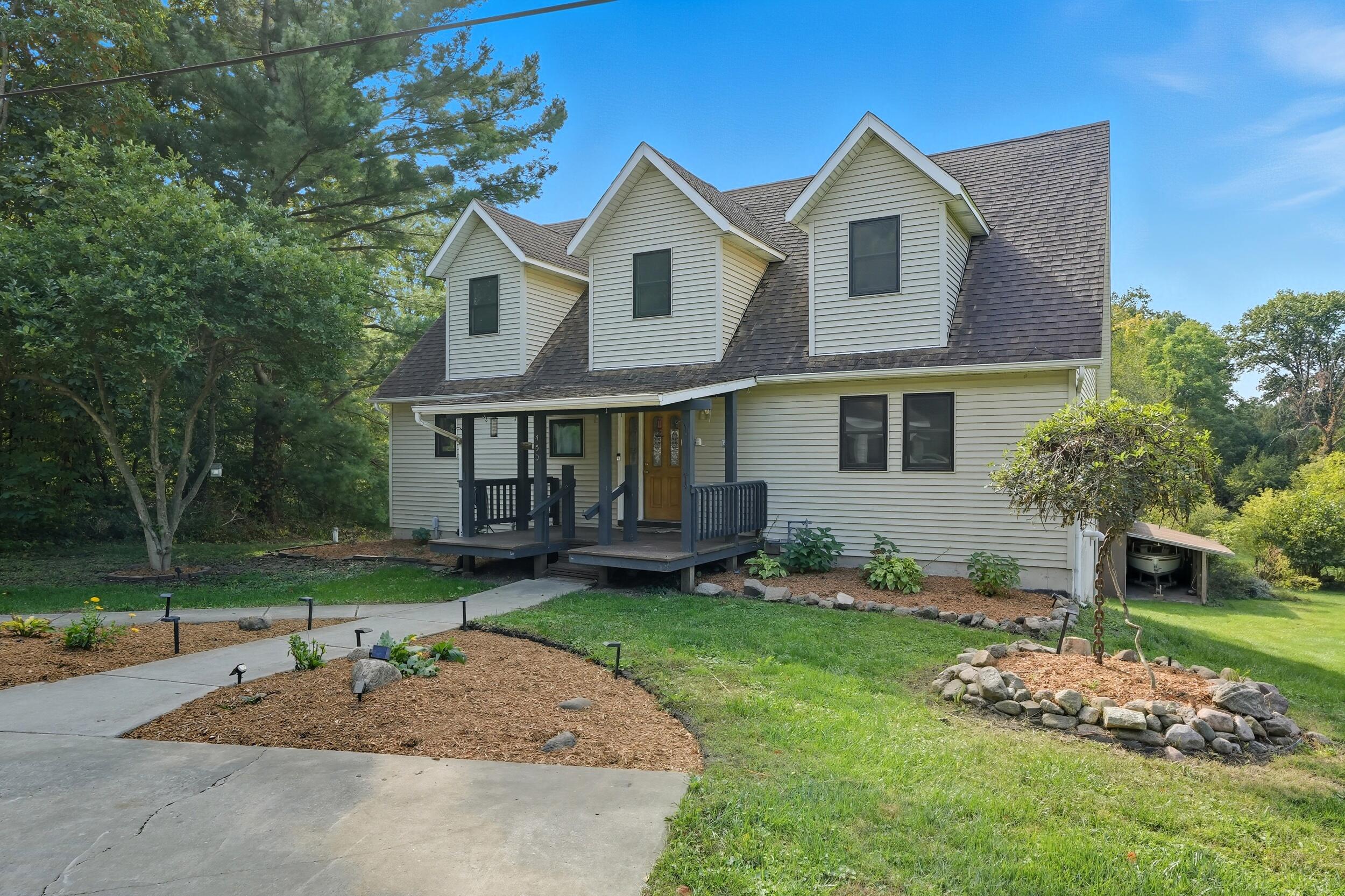450 East Greening Road Chesterton, IN 46304 - Photo 4 of 56 a front view of a house with a garden and trees