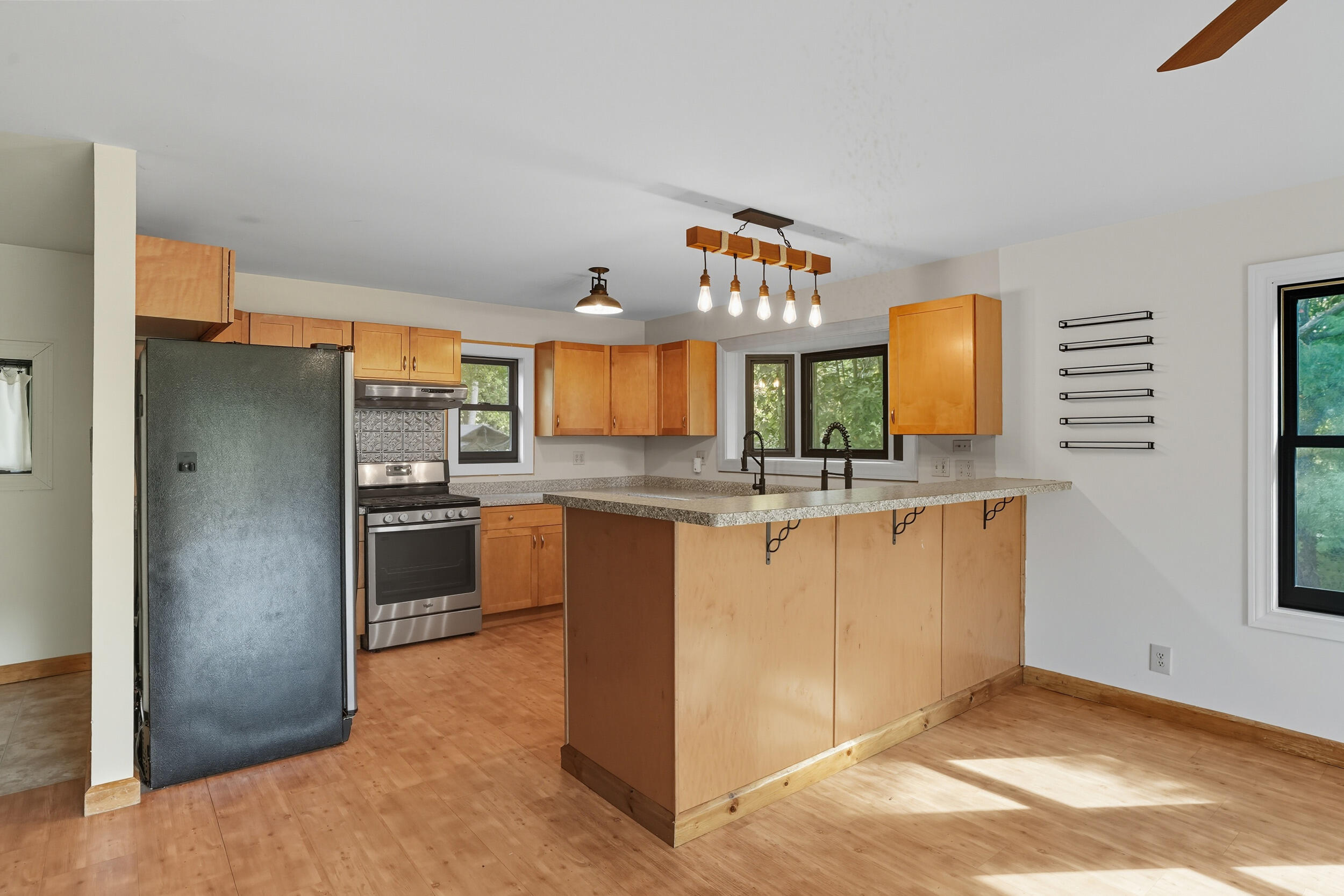450 East Greening Road Chesterton, IN 46304 - Photo 9 of 56 a kitchen with granite countertop a refrigerator stove and sink