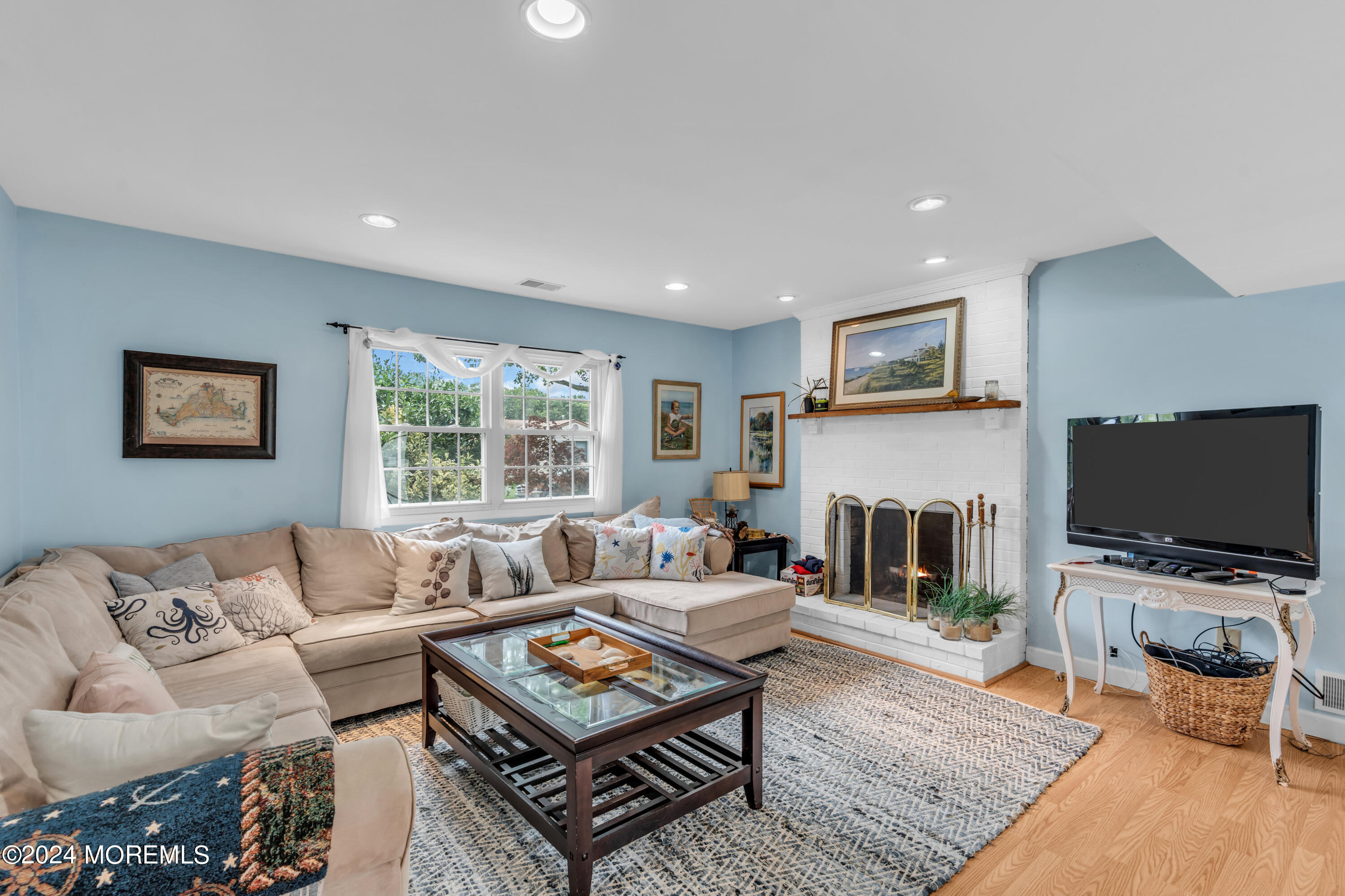 332 Emberly Road Brick, NJ 08723 - Photo 8 of 50 a living room with furniture a flat screen tv and a fireplace