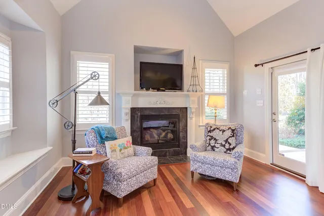 a bedroom with a bed and a dresser with wooden floor