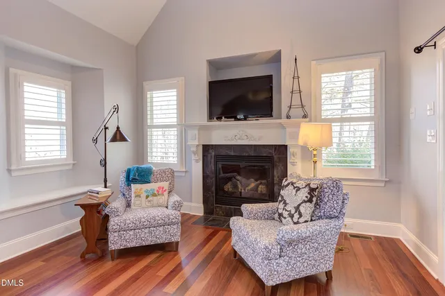 a bedroom with a bed and a flat tv screen on dresser
