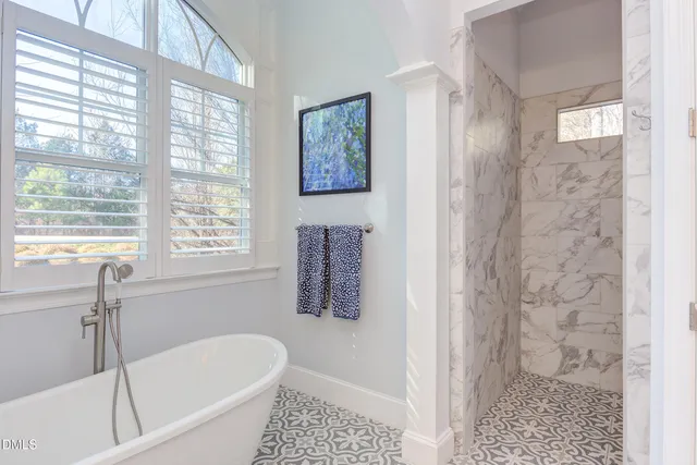 a living room with furniture a dining table and a potted plant