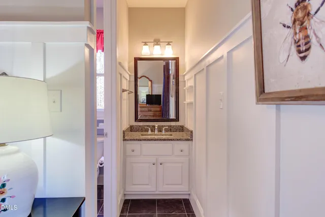 a view of dirt yard with a large tree