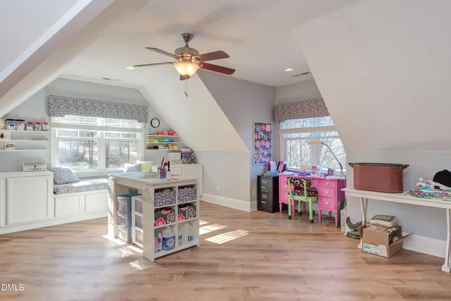 a view of a house with a yard and large trees