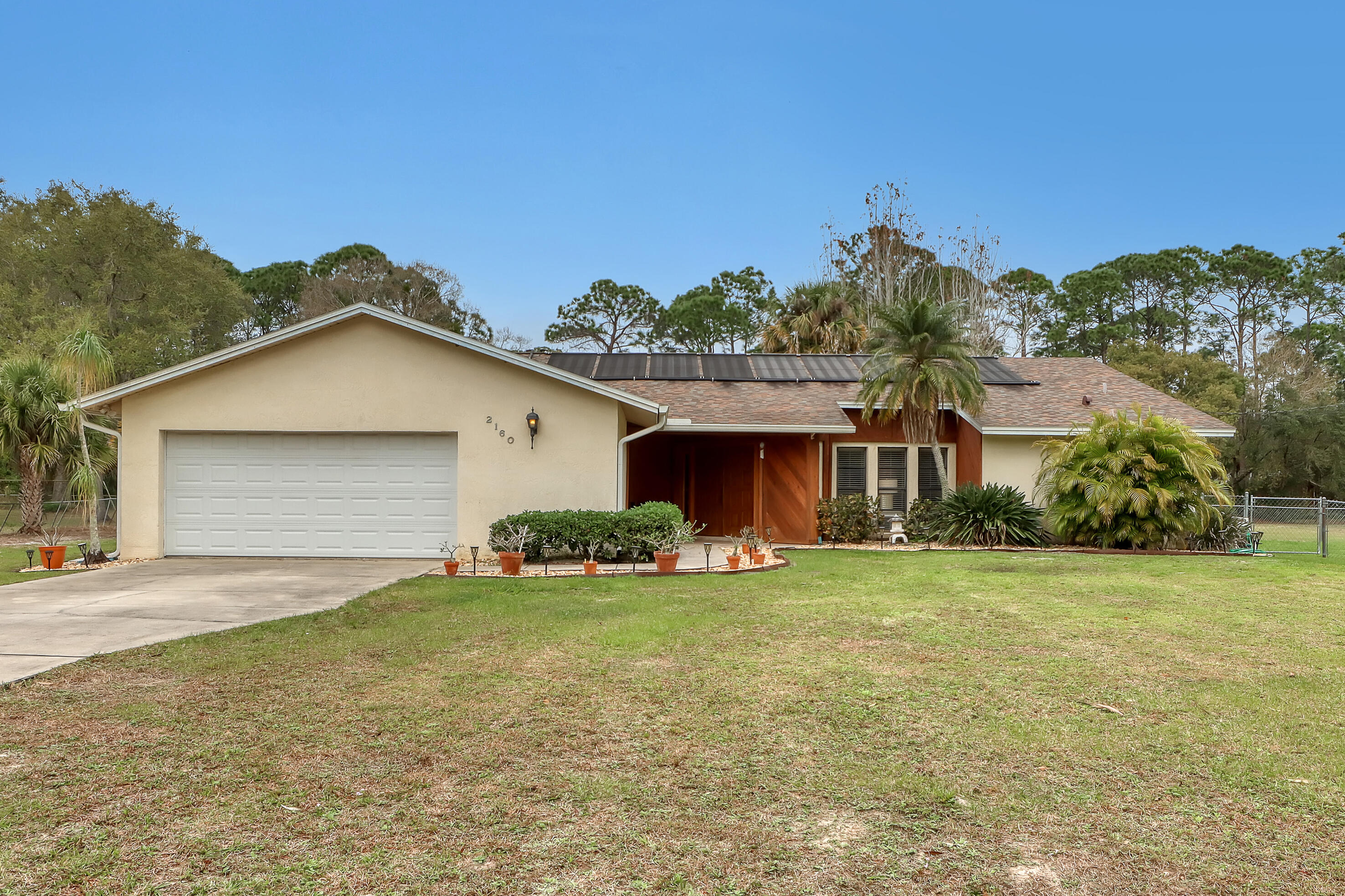 a view of a house with a yard and garage