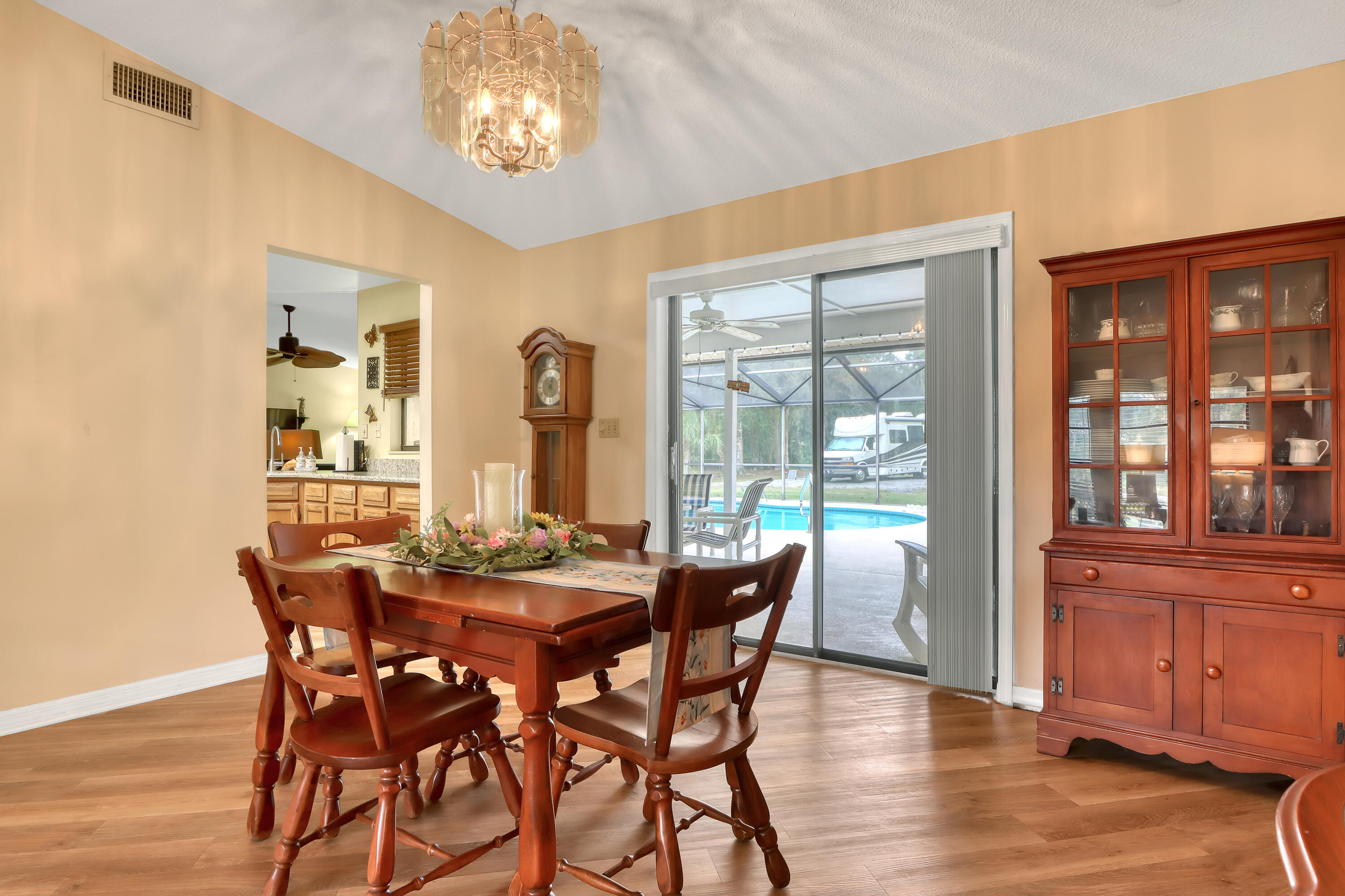 2160 Winston Drive Cocoa, FL 32926 - Photo 12 of 52 a view of a dining room with furniture large windows and wooden floor