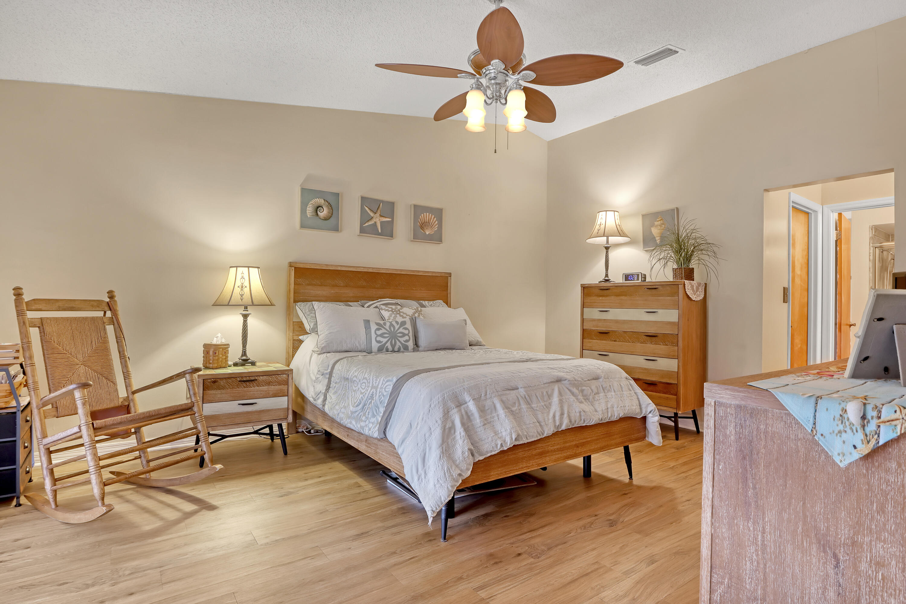 2160 Winston Drive Cocoa, FL 32926 - Photo 23 of 52 a bedroom with a bed chandelier and a dresser
