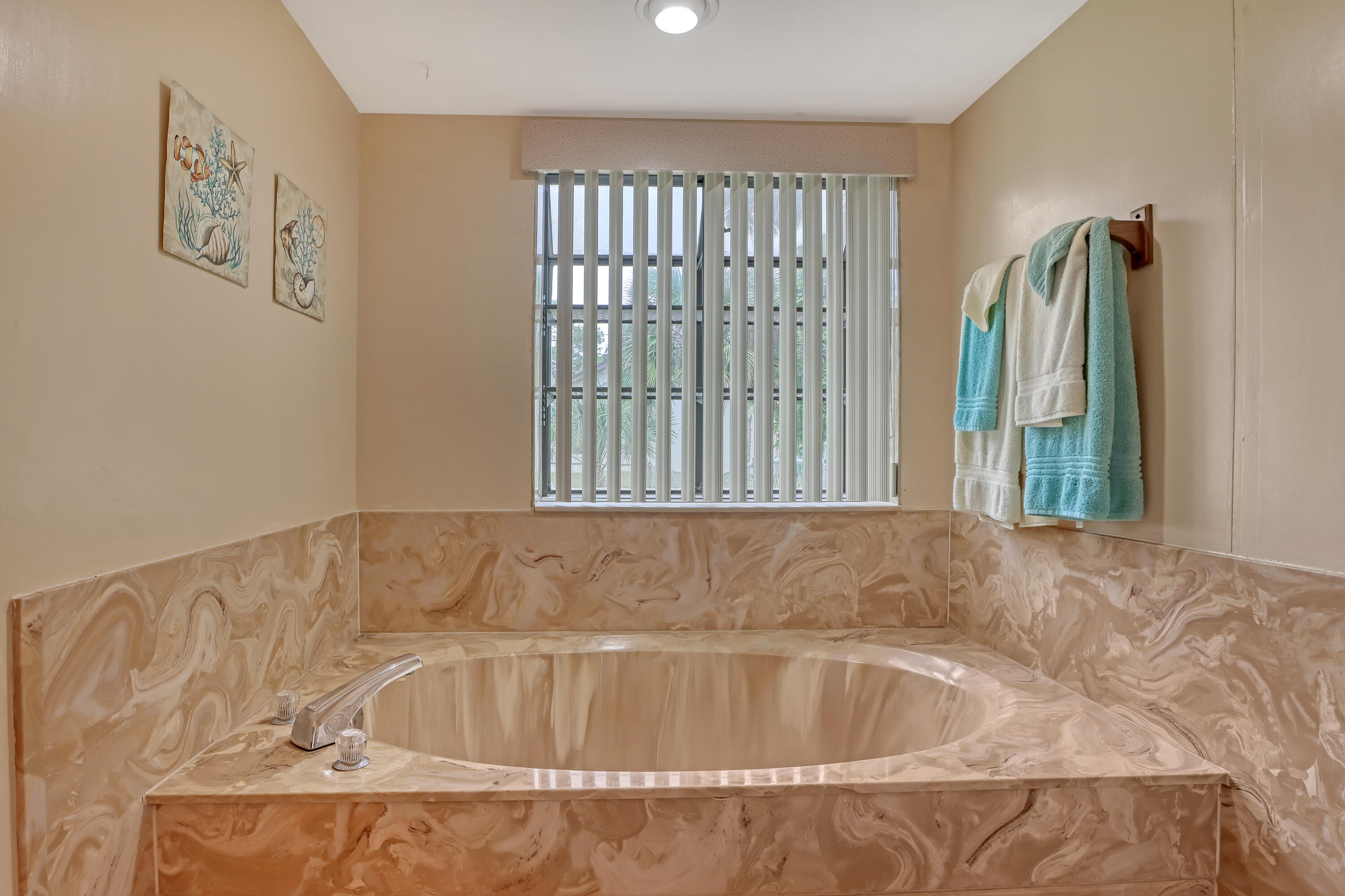 2160 Winston Drive Cocoa, FL 32926 - Photo 29 of 52 a bath tub sitting in a bathroom next to a window