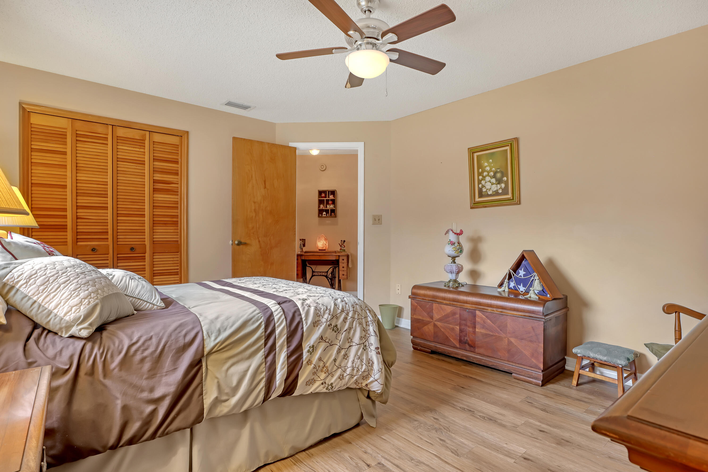 2160 Winston Drive Cocoa, FL 32926 - Photo 31 of 52 a bedroom with a bed and a chandelier