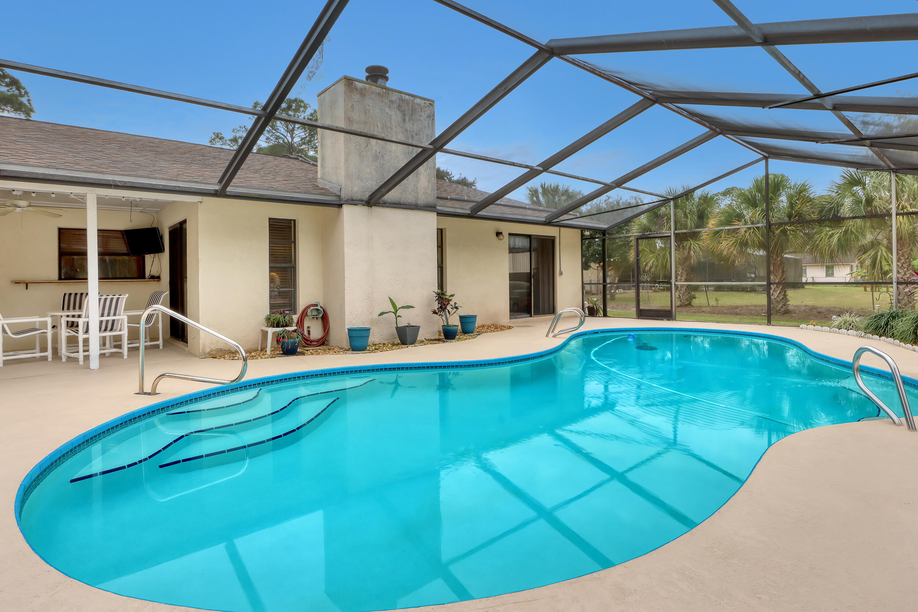 2160 Winston Drive Cocoa, FL 32926 - Photo 43 of 52 a view of a swimming pool with chairs