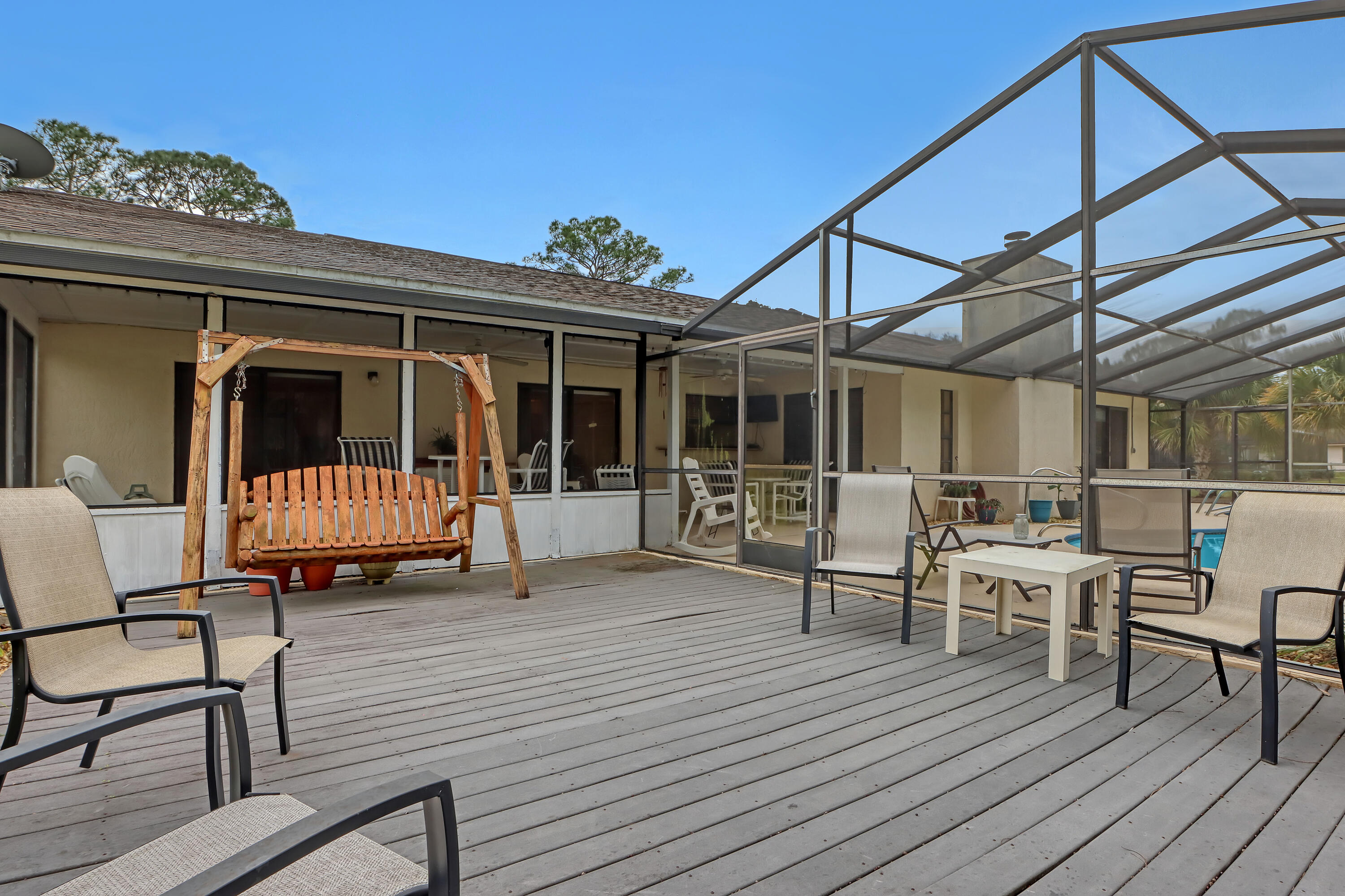 2160 Winston Drive Cocoa, FL 32926 - Photo 45 of 52 a view of a deck with table and chairs with wooden floor and fence