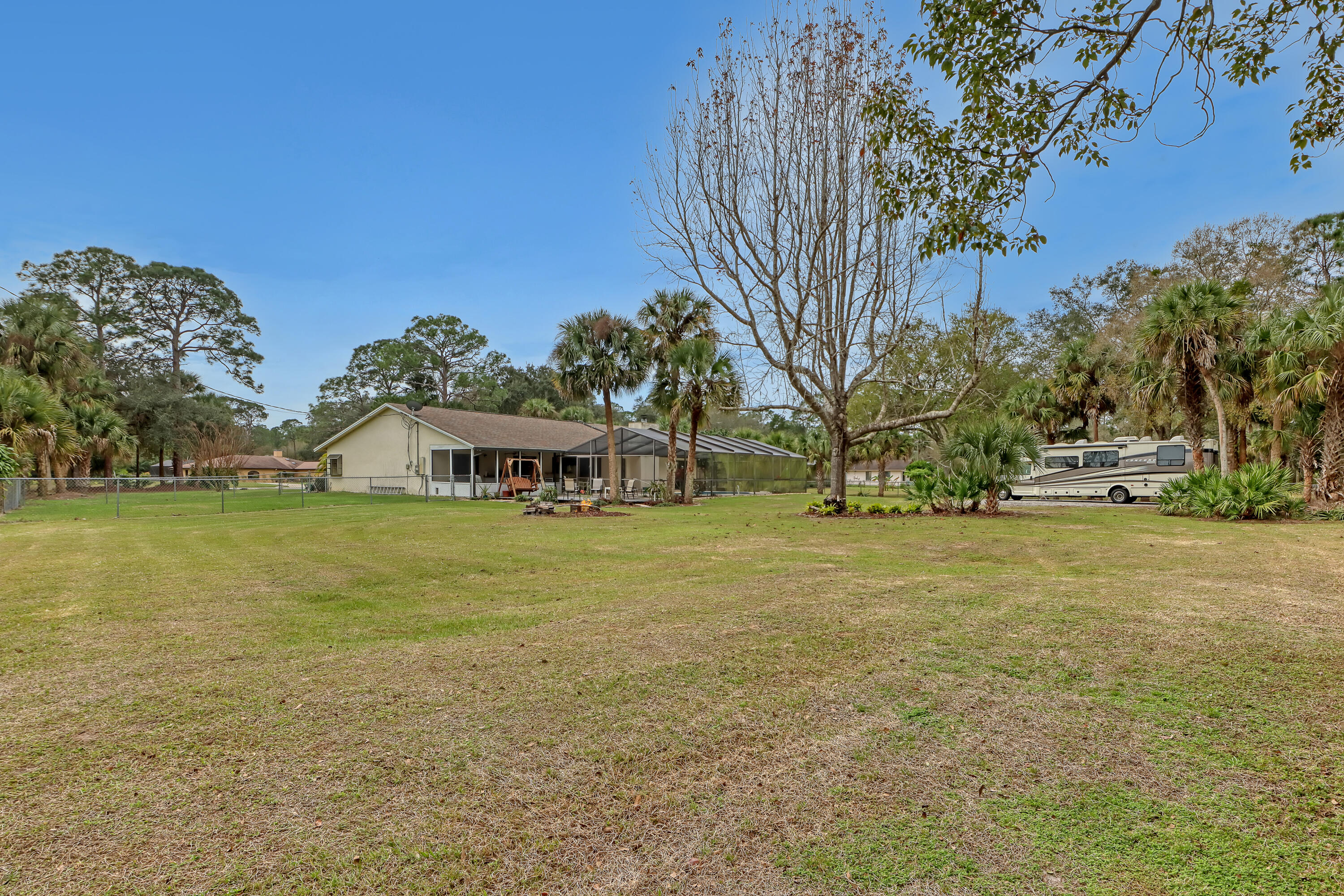 2160 Winston Drive Cocoa, FL 32926 - Photo 48 of 52 a yellow and red house with a trees in the background