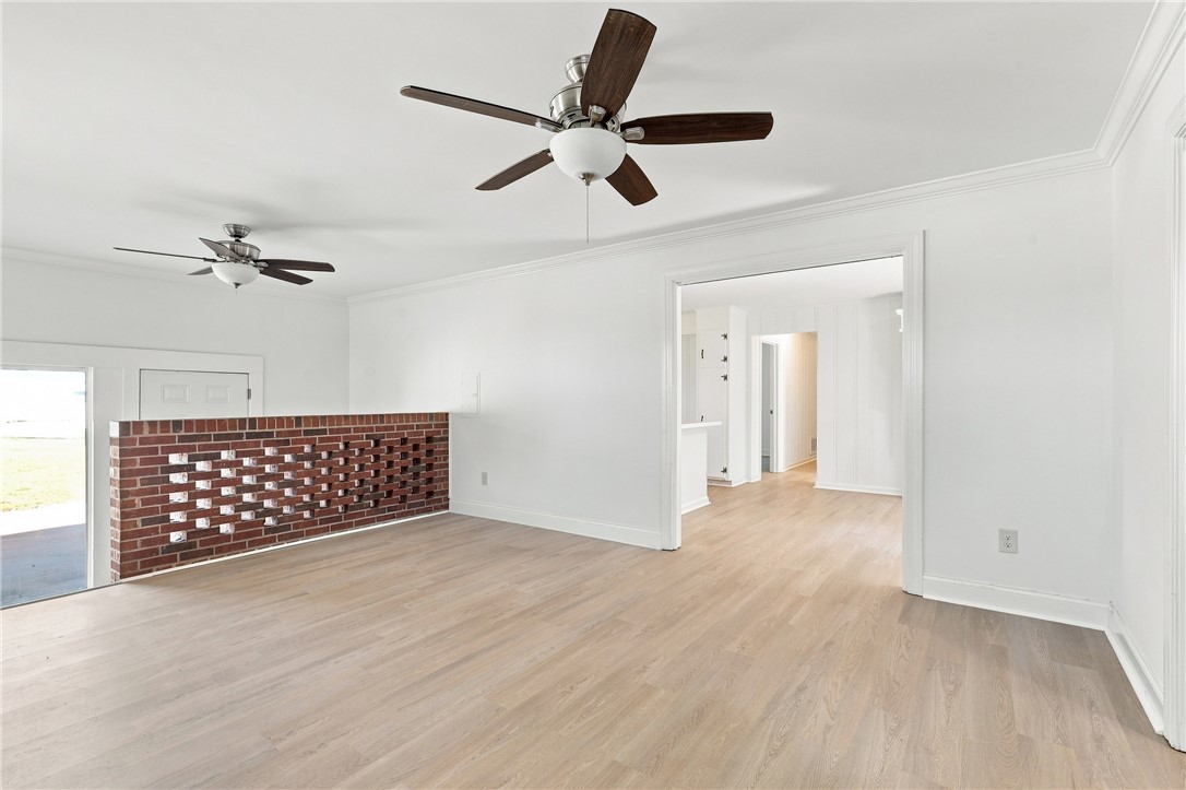 205 Timms Road Piedmont, SC 29673 - Photo 6 of 36 Refined floors and clean crown molding enhance this open-concept living space.