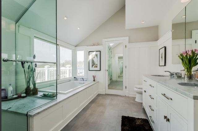 8 Nearwater Road Rowayton, CT 06853 - Photo 16 of 26 a bathroom with a granite countertop tub a sink and a large mirror
