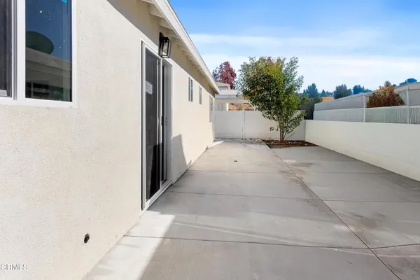 a view of a pathway both side of house