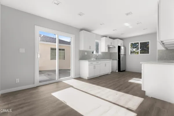 a view of a kitchen with a sink and a large window