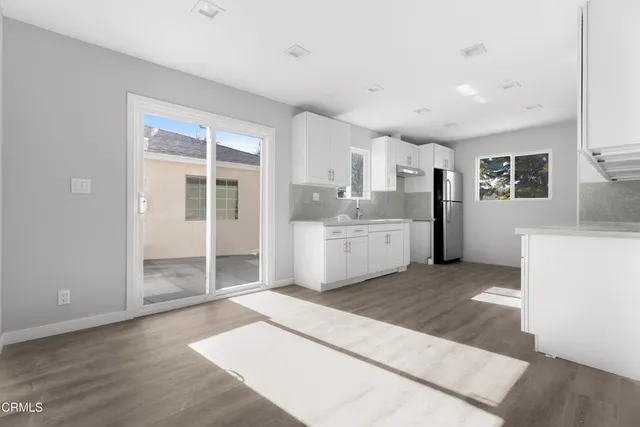 a view of a kitchen with a sink and a large window