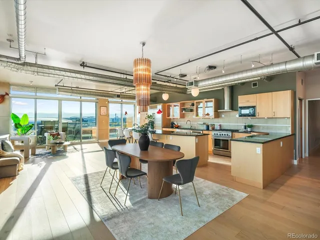 a room with stainless steel appliances kitchen island granite countertop furniture and a large window