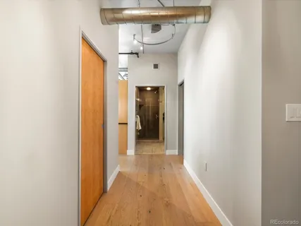 a view of a hallway with wooden floor