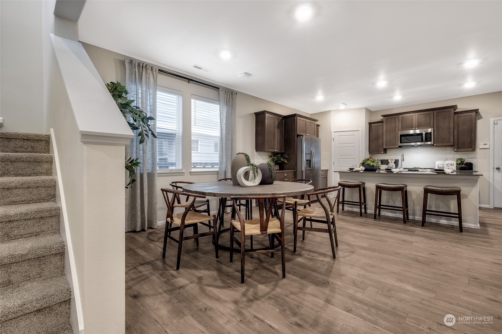 1607 Sultan Basin Road, Unit 1167 Sultan, WA 98294 - Photo 3 of 18 a view of a dining room with furniture and wooden floor
