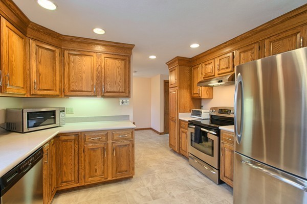 37 Bailey Road Andover, MA 01810 - Photo 3 of 30 a kitchen with stainless steel appliances granite countertop a refrigerator and a stove top oven