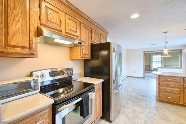 37 Bailey Road Andover, MA 01810 - Photo 4 of 30 a kitchen with stainless steel appliances granite countertop a stove and a refrigerator