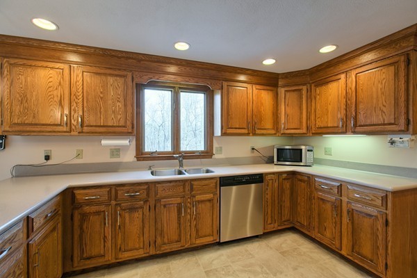 37 Bailey Road Andover, MA 01810 - Photo 5 of 30 a kitchen with a sink window and cabinets