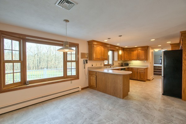 37 Bailey Road Andover, MA 01810 - Photo 6 of 30 a large kitchen with a large window and stainless steel appliances