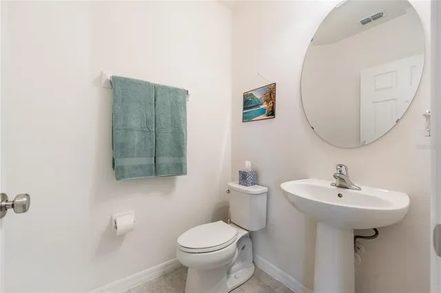a bathroom with a sink toilet and mirror