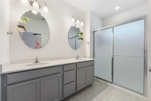 a bathroom with a double vanity sink and a mirror
