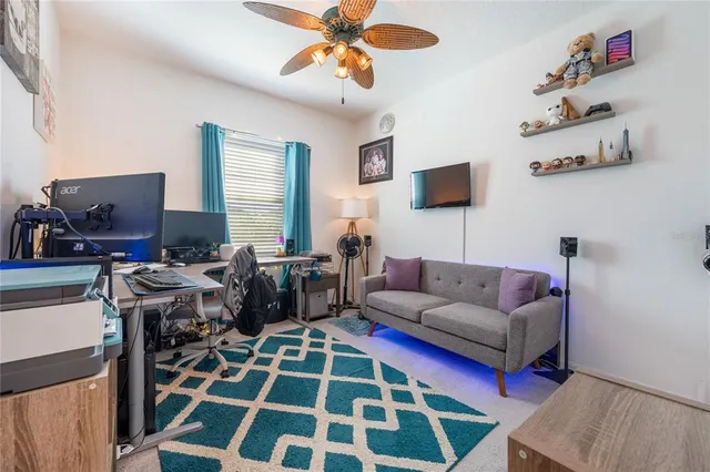 a living room with furniture a rug and a flat screen tv