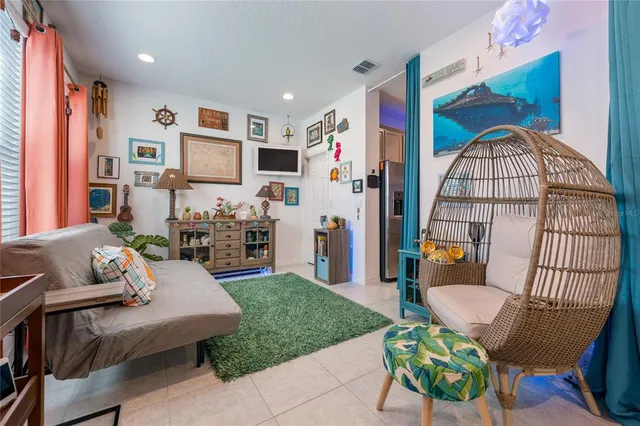 a living room with furniture and a dining table with rug