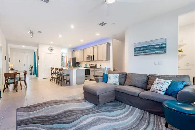 a living room with furniture and kitchen view