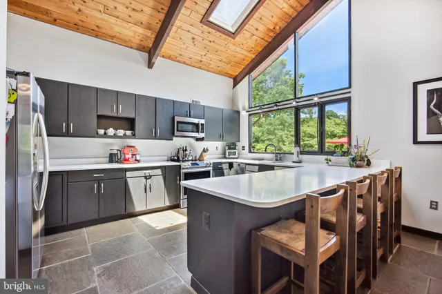a kitchen with a sink stove and microwave