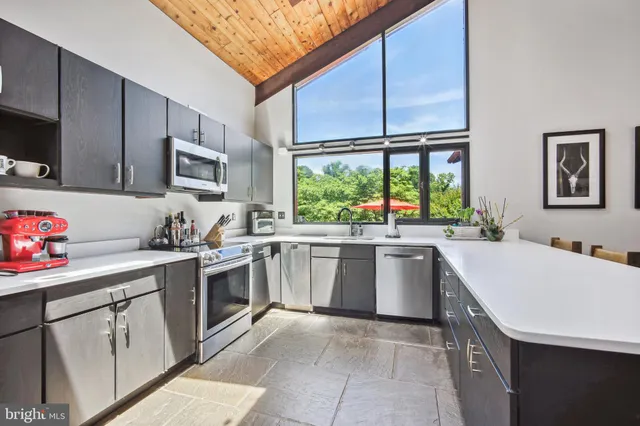 a kitchen with a sink stove and cabinets