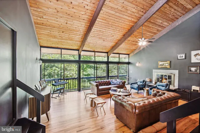 a living room with furniture a wooden floor and a large window