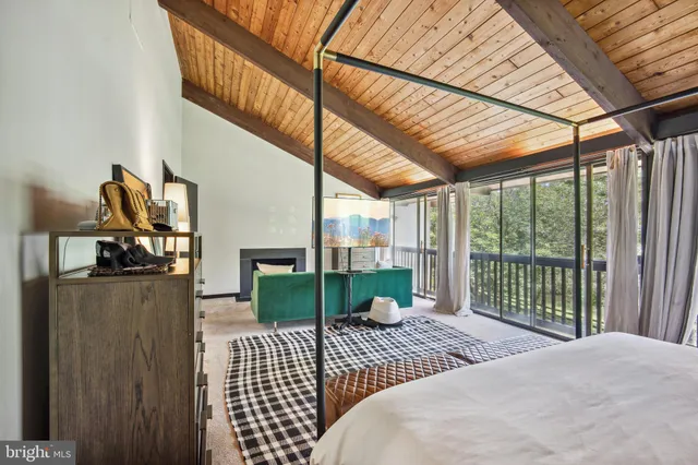 a bedroom with a bed and large window