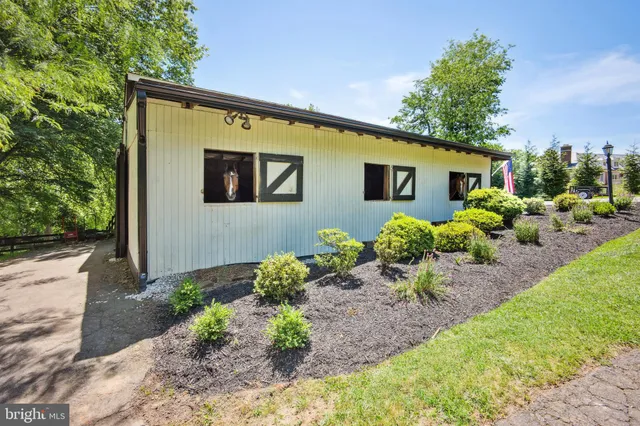 a house with lots of trees in front of it