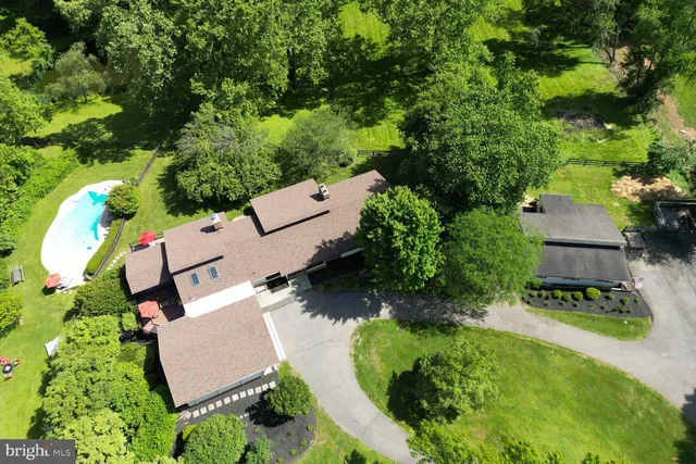 an aerial view of a house with garden space and street view