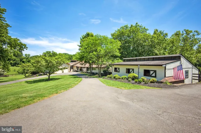 a view of house with outdoor space and trees
