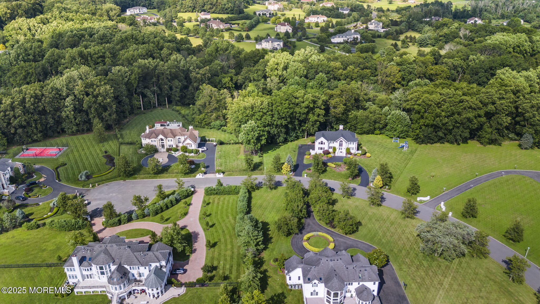 16 Shallow Brook Road Morganville, NJ 07751 - Photo 13 of 37 an aerial view of a house with a yard and lake view in back