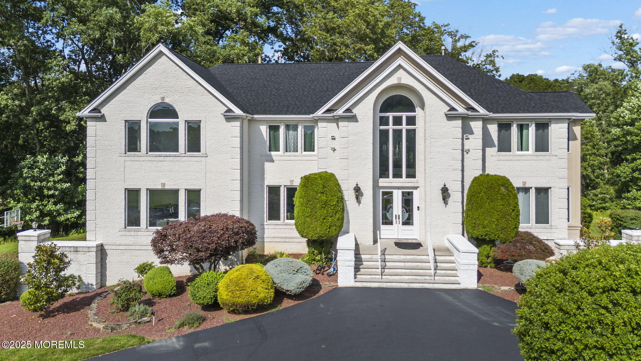 16 Shallow Brook Road Morganville, NJ 07751 - Photo 2 of 37 a front view of a house with garden