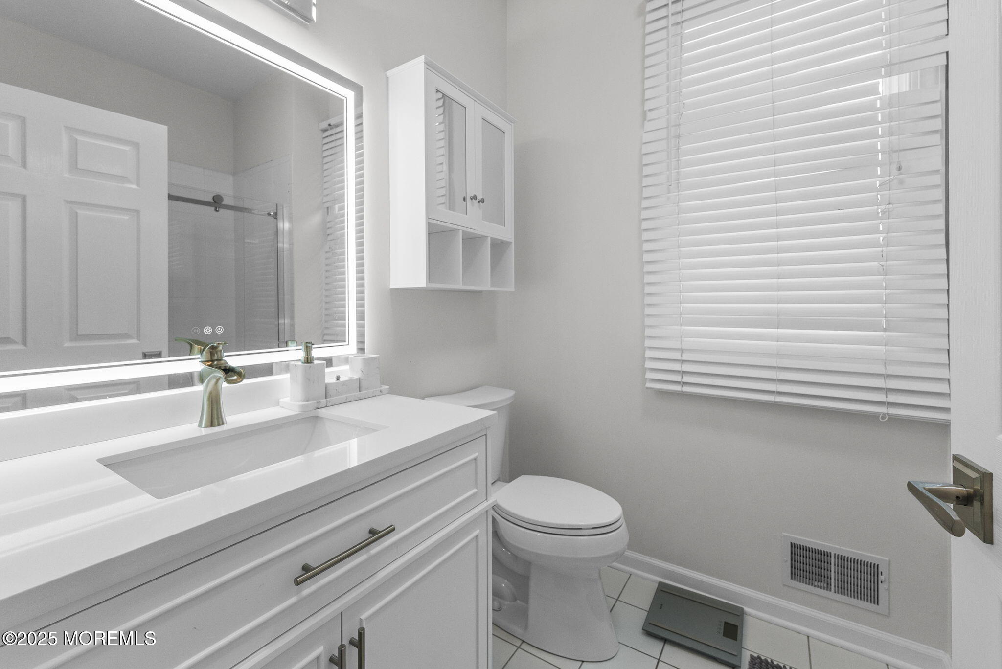 16 Shallow Brook Road Morganville, NJ 07751 - Photo 24 of 37 a bathroom with a sink a toilet and vanity