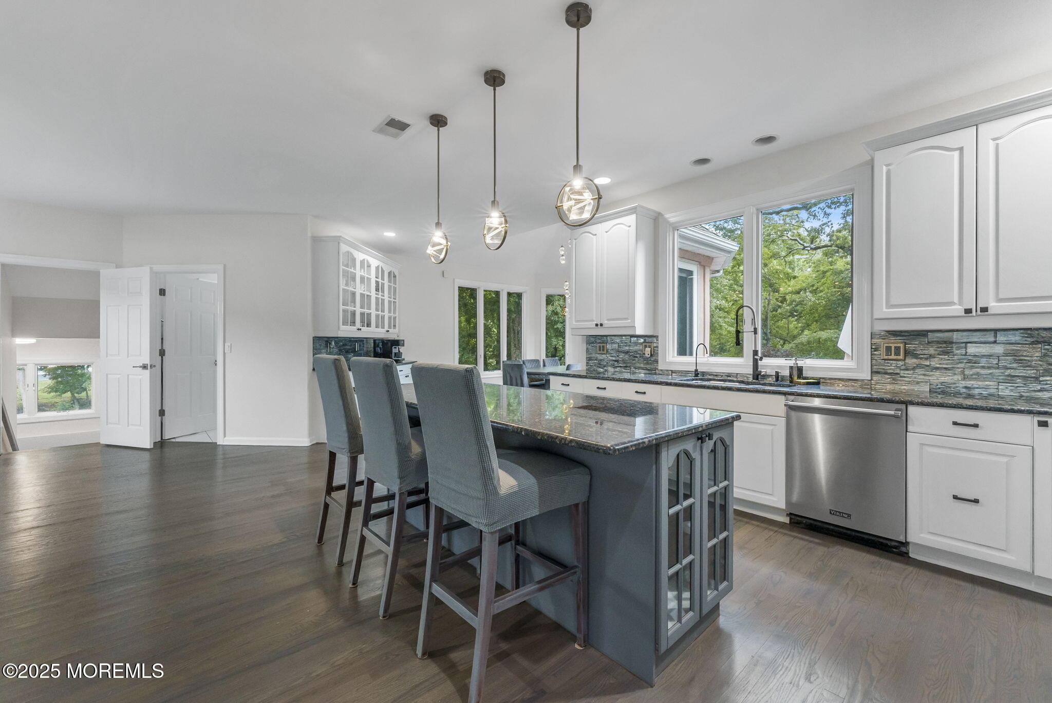 16 Shallow Brook Road Morganville, NJ 07751 - Photo 28 of 37 a kitchen with stainless steel appliances granite countertop a stove a refrigerator a kitchen island a sink and a wooden floors