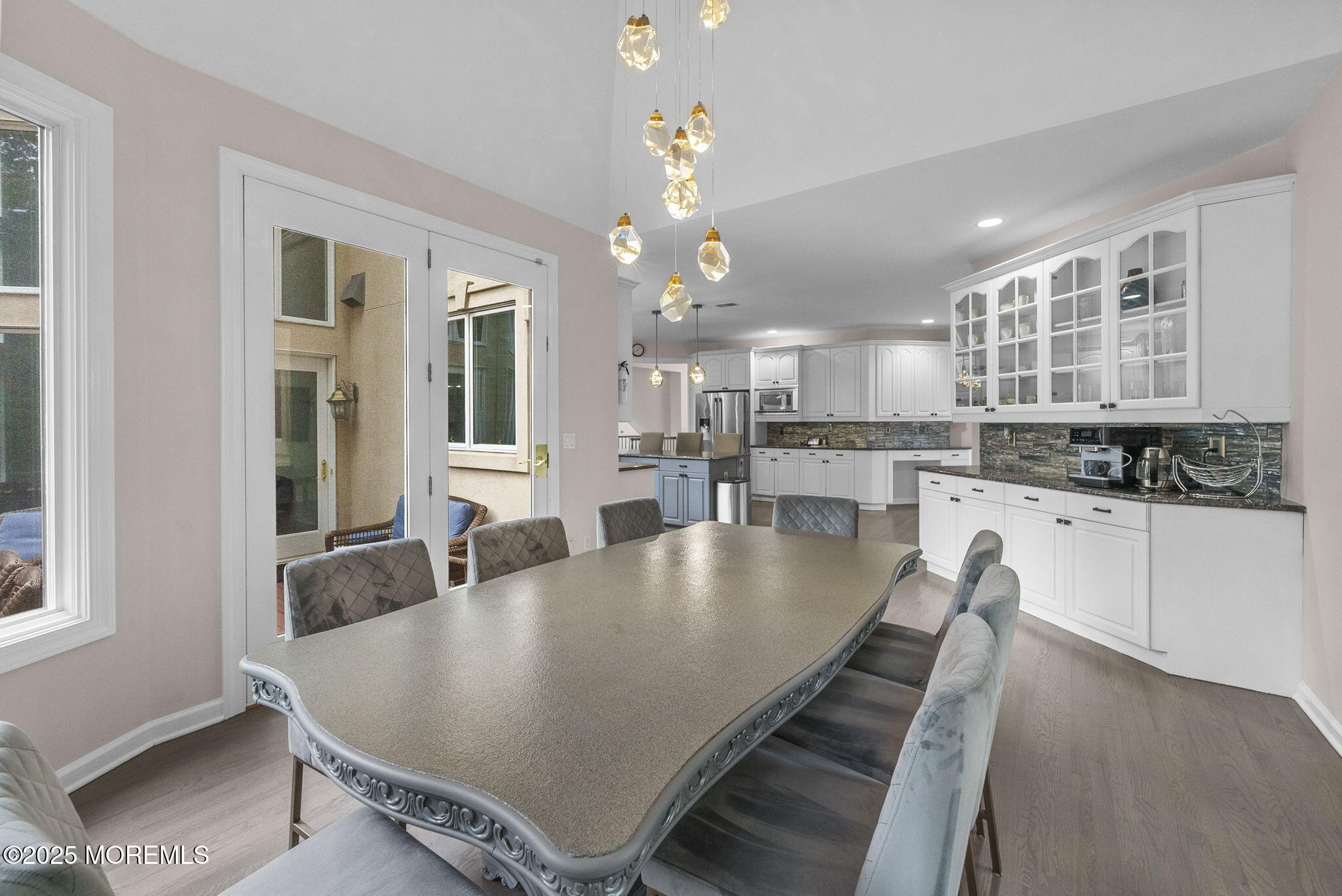 16 Shallow Brook Road Morganville, NJ 07751 - Photo 31 of 37 a large kitchen with kitchen island a stove a table and chairs in it