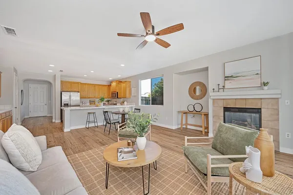 a living room with furniture and kitchen view