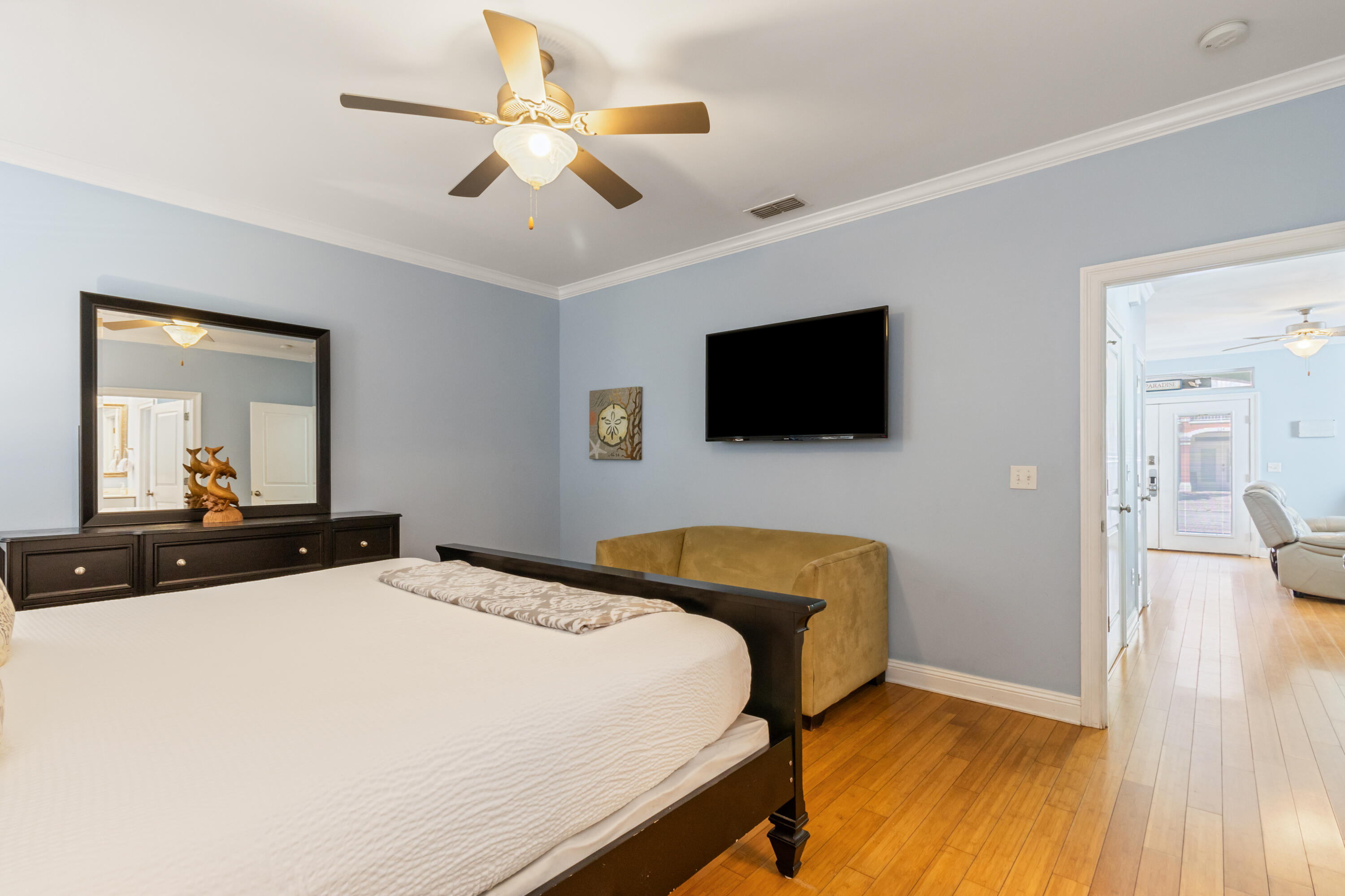 235 Kono Way Destin, FL 32541 - Photo 15 of 42 a bedroom with a bed a flat screen tv and a chandelier