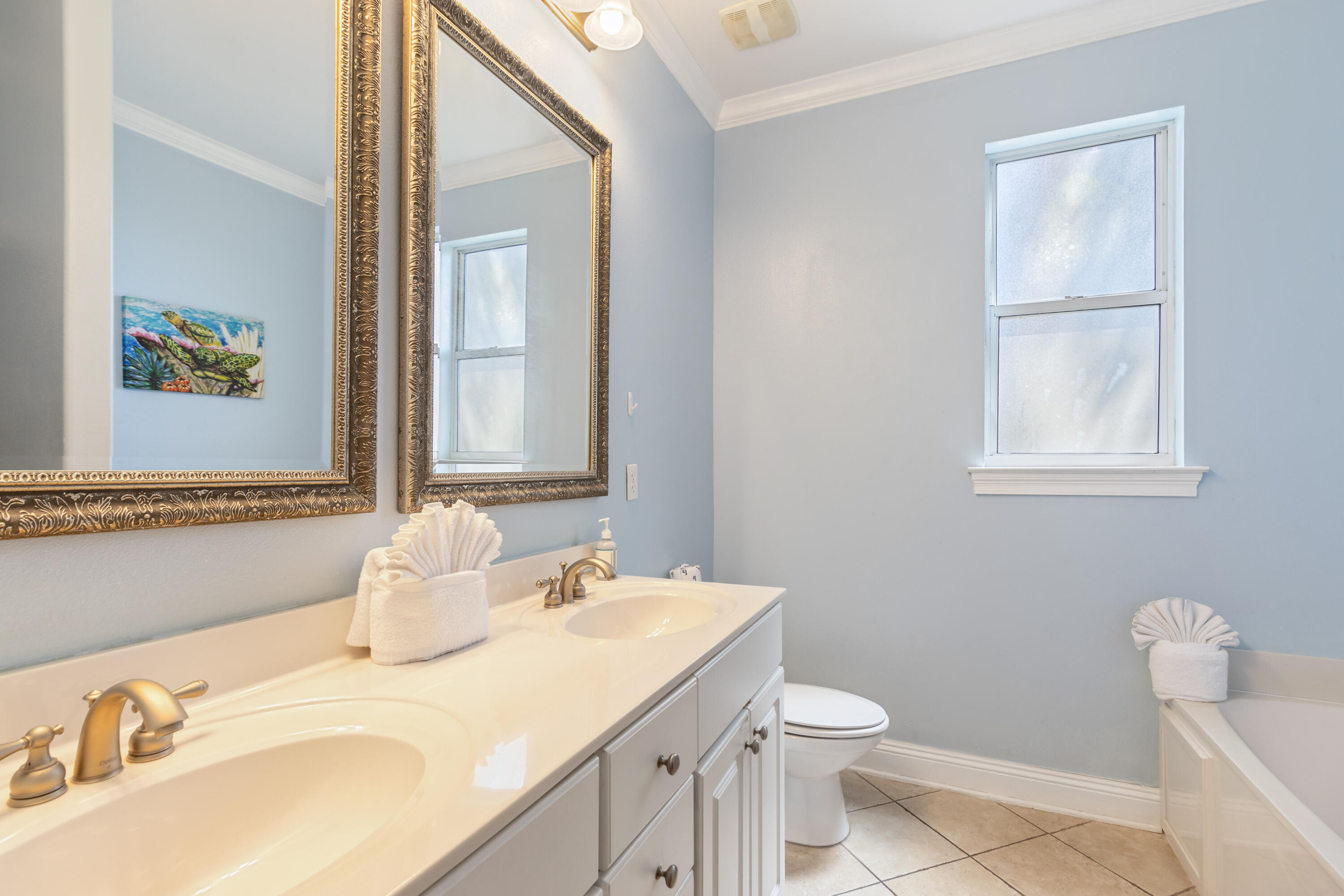 235 Kono Way Destin, FL 32541 - Photo 16 of 42 a bathroom with a granite countertop sink toilet and mirror