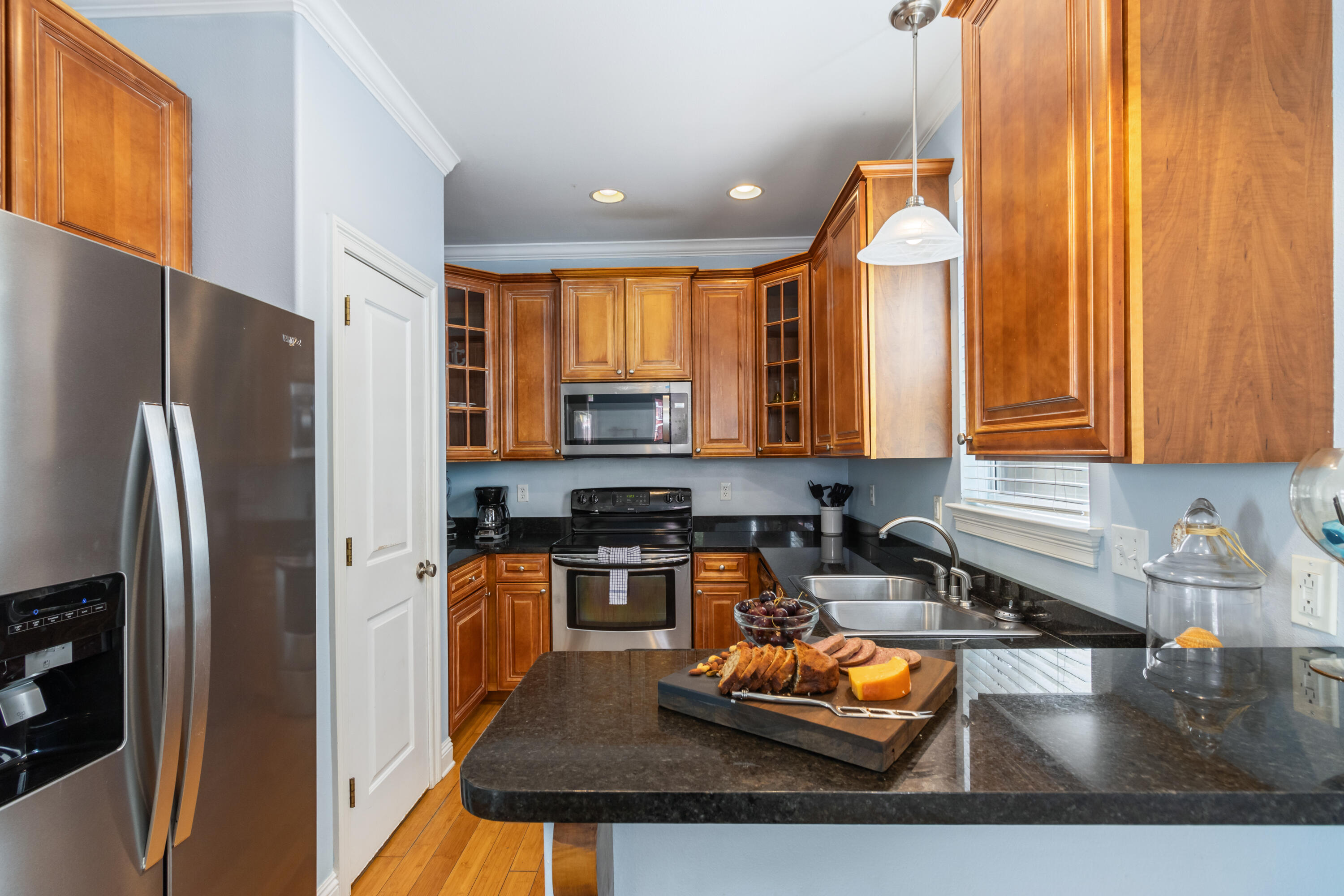 235 Kono Way Destin, FL 32541 - Photo 10 of 42 a kitchen with stainless steel appliances granite countertop a refrigerator a stove and a sink